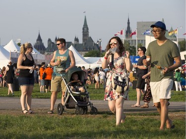Music fans arrive as the 25th anniversary edition of RBC Bluesfest gets underway on the grounds of the Canadian War Museum in Lebreton Flats. Photo by Wayne Cuddington/ Postmedia