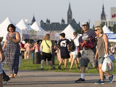 Music fans arrive as the 25th anniversary edition of RBC Bluesfest gets underway on the grounds of the Canadian War Museum in Lebreton Flats. Photo by Wayne Cuddington/ Postmedia