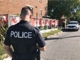 An Ottawa police officer at the scene of a stabbing at the corner of Shakespeare Street and Granville Street in Vanier.