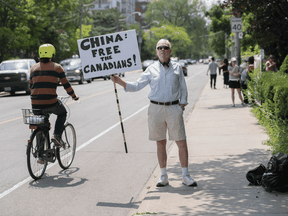 Lorne Hicks protests against the Chinese imprisonment of two Canadians, in front of the Chinese Consulate in Toronto on July 10, 2019.