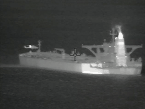 A helicopter hovers near the Iranian oil tanker Grace 1 off Gibraltar, in a night vision photograph released July 4, 2019.
