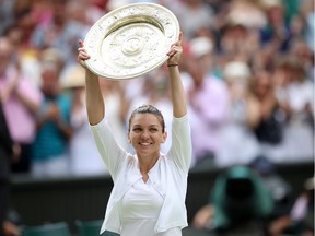 Romania's Simona Halep poses with the trophy as she celebrates after winning the final against Serena Williams of the U.S.