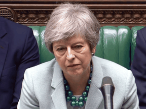 Britain's Prime Minister Theresa May listens as opposition leader Jeremy Corbyn speaks in the House of Commons in London on March 25, 2019.