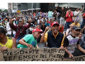 Fired oil contractor employees protest near the Venezuelan chancellery in Caracas, Venezuela June 20, 2019.