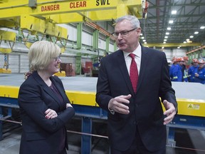 Irving Shipbuilding president Kevin McCoy, right, and Public Services Minister Carla Qualtrough chat at a ceremony where the first piece of steel was cut on the third Arctic patrol vessel for the Royal Canadian Navy, in Halifax on Tuesday, Dec. 19, 2017. Irving is building five to six Arctic patrol vessels under Ottawa's national shipbuilding strategy.