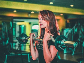 FILE: A woman lifts weights.