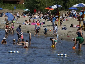 People enjoy the warm weather near Britannia Beach in Ottawa on Sunday, July 7, 2019.