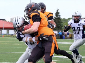 Victor Paajanen of the Sudbury Spartans tackles Alex Gauthier of the Ottawa Sooners during Northern Football Conference action at James Jerome Sports Complex.