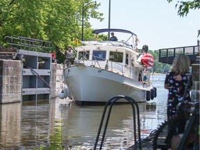 Files:A large yacht motors through the swing bridge at Hog's Back as it heads into the locks and then up the Rideau Canal.