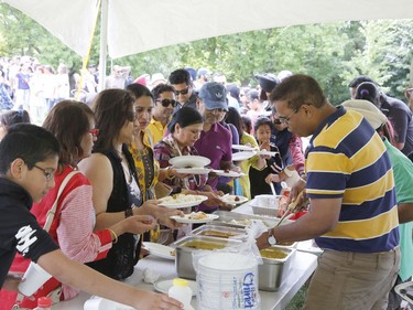 People take part in a BBQ organized by Punjabi Community Health Services Ottawa and the Punjabi School at Vincent Massey Park on Saturday.