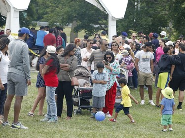 People take part in a BBQ organized by Punjabi Community Health Services Ottawa and the Punjabi School on Saturday.