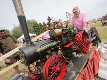 Wally Biernacki of Orono, Ontario operates a model steam tractor as 250 threshing machines attempt to break the world record by operating simultaneously on the same site in St. Albert on Sunday, August 11, 2019.