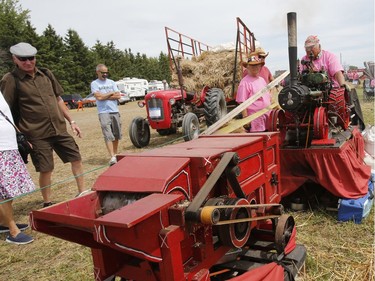 Wally Biernacki of Orono, Ontario operates a model thresher as 250 threshing machines attempt to break the world record by operating simultaneously on the same site in St. Albert on Sunday, August 11, 2019.