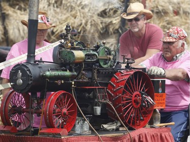 Wally Biernacki of Orono, Ontario operates a model steam tractor as 250 threshing machines attempt to break the world record by operating simultaneously on the same site in St. Albert on Sunday, August 11, 2019.