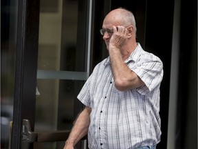 Former scout leader Donald Sullivan of Ottawa tries to cover his face as he leaves the Ottawa Courthouse on Aug. 13, 2019.