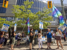 About three dozen Ontario Public Service Employees Union members, most from CHEO, gathered outside a government office building on Preston Street Thursday to protest the provincial government's cuts to autism care.