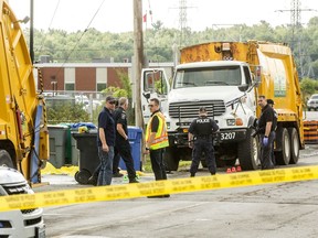 Police and investigators were at the Cyrville Road site of a fatality Monday morning, after a man was pinned between two garbage trucks.