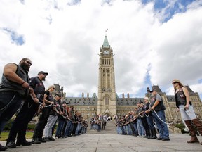 Bikers Against Child Abuse gather on Parliament Hill on Saturday, Aug. 31, 2019.  Members hold a chain that represents the vicious chain of child abuse.