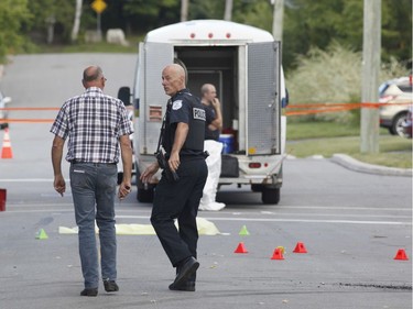 Police investigate a car fire in Buckingham, Quebec on Saturday.