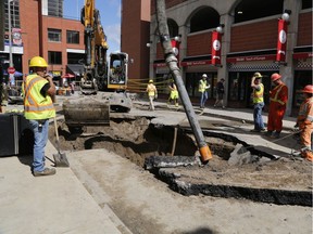 Workers repair a water main break in the Byward Market in Ottawa on Saturday, August 31, 2019.