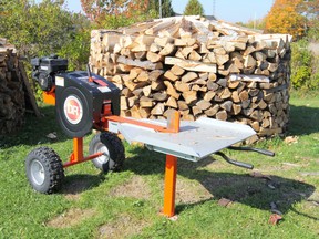 This gas-powered wood splitter uses the inertia of spinning flywheels to create very fast splitting action. A splitter like this is roughly twice as fast as a traditional hydraulic wood splitter.