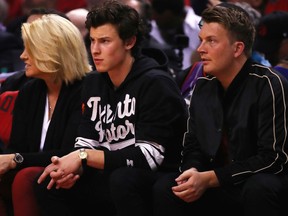 Justin Stirling, right, attends a Toronto Raptors playoff game against the Golden State Warriors in June with singer and songwriter Shawn Mendes.