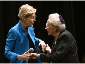 SIOUX CITY, IA - AUGUST 19: Democratic presidential candidate Sen. Elizabeth Warren (D-MA) (L) is escorted on stage by Marcella LeBeau at the Frank LaMere Native American Presidential Forum on August 19, 2019 in Sioux City, Iowa.