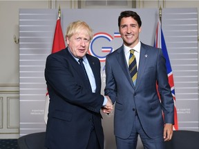 British Prime Minister Boris Johnson (L) shakes hands with Prime Minister of Canada Justin Trudeau on August 24, 2019 in Biarritz, France. The French southwestern seaside resort of Biarritz is hosting the 45th G7 summit from August 24 to 26. High on the agenda will be the climate emergency, the US-China trade war, Britain's departure from the EU, and emergency talks on the Amazon wildfire crisis.
