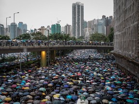 Thousands of anti-government protesters march on a street after leaving a rally in Victoria Park in Hong Kong on Sunday. Pro-democracy protesters have continued rallies on the streets of Hong Kong against a controversial extradition bill since June 9, 2019.