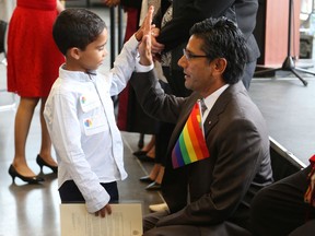 Youssef Salem of Egypt is now a Canadian Citizen and gets a high five from Yasir Naqvi, August 22, 2019.  Immigration, Refugees and Citizenship Canada and the Institute for Canadian Citizenship (ICC) welcome 50 new citizens at a special citizenship ceremony at the Lansdowne – Horticultural Building.    Jean Levac/Postmedia