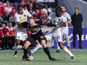 Jeremy Gagnon-LaPare of the Fury gets manhandled by Riverhounds’ Mouhamed Dabo (left) and Kenardo Forbes last night at TD Place. Pittsburgh won 4-0, handing the Fury its worst home loss in franchise history.  Steve Kingsman/Freestyle Photography for Ottawa Fury FC