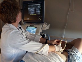 Nurse doing ultrasound looking at monitors