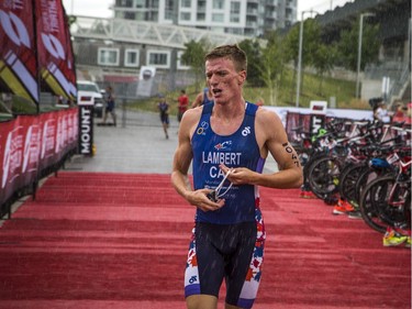 Nicholas Lambert gets caught in the rain as he makes his way back to the canal for the second swim, during the event Saturday August 3, 2019.   Ashley Fraser/Postmedia