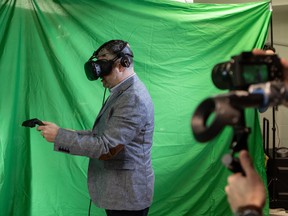 Dr. Adam Sachs holding 3D virtual reality wands.