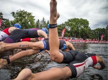 The Youth and Junior Boys Enduro Race competitors dive off the dock into the Rideau Canal during Saturday's race.