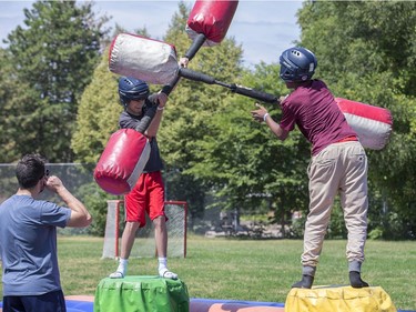 Kenneth Meio, 13, left, and Emmadson Jean-Baptiste, 13, battle with padded batons as the Ottawa Senators Foundation held a picnic at Jules Morin Park.