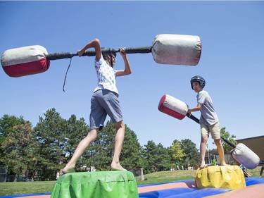 Peter Troung, 12 (L) and Nguyen Pham, 12, battle with padded batons as the Ottawa Senators Foundation held a picnic at Jules Morin Park.