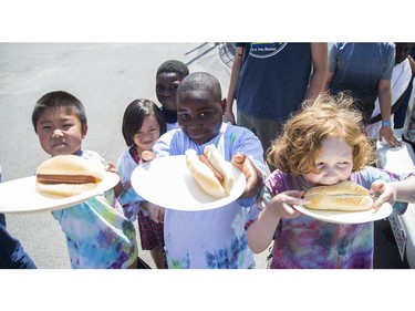 Kids show off their hotdogs as the Ottawa Senators Foundation held a picnic at Jules Morin Park.