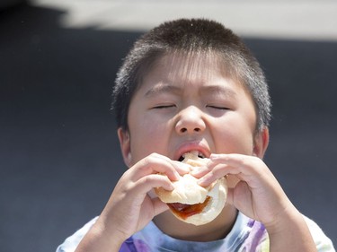 Jiaphu Nguyen, 8, enjoys his hotdog as the Ottawa Senators Foundation held a picnic at Jules Morin Park.