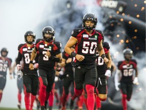 Ottawa Redblacks #50 Louis-Philippe Bourassa runs onto the field with the team before the game against the Hamilton Tiger-Cats at TD Place on Saturday.