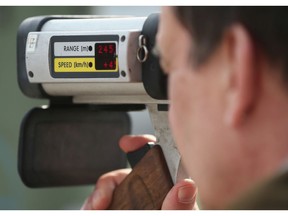 A policeman with a radar gun.