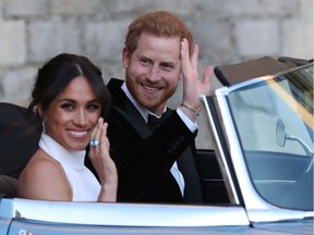 Duchess of Sussex and Prince Harry, Duke of Sussex wave as they leave Windsor Castle after their wedding to attend an evening reception at Frogmore House, hosted by the Prince of Wales on May 19, 2018 in Windsor, England.