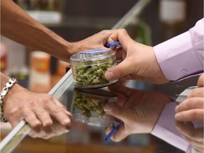 A budtender helps a customer.