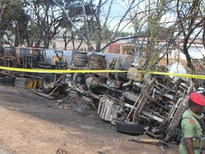 Police tape cordons off the area where the carcass of a burnt out fuel tanker is seen along the side of the road following an explosion on August 10, 2019, in Morogoro, 200 kilometres (120 miles) west of the Tanzanian capital Dar es Salaam.