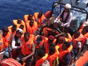 An inflatable dinghy belonging to the 'Ocean Viking' rescue ship, operated by French NGOs SOS Mediterranee and Medecins sans Frontieres (MSF), transports migrants rescued from their dinghy during an operation in the Mediterranean Sea on August 12, 2019.