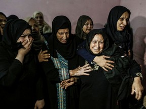 Relatives of 26-year-old Palestinian Mohammed Samir al-Taramsi, one of three armed Palestinians killed overnight in Israeli fire along the border with the Gaza Strip, mourn during his funeral in Beit Lahya in northern Gaza strip on Sunday.