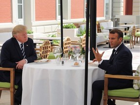 US President Donald Trump (L) sits to lunch with French President Emmanuel Macron, at the Hotel du Palais in Biarritz, south-west France on August 24, 2019, on the first day of the annual G7 Summit attended by the leaders of the world's seven richest democracies, Britain, Canada, France, Germany, Italy, Japan and the United States.