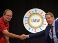 UAW President Gary Jones (L) shakes hands with Ford Motor Co Chairman Bill Ford at the start of contract talks between the union and the automaker in Detroit, Michigan, U.S., July 15, 2019.