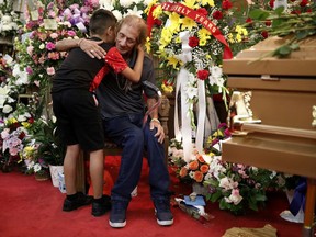 Antonio Basco, whose wife Margie Reckard was murdered during a shooting at a Walmart store, is embraced next to her coffin at a visitation service to which he had invited the public in El Paso, Texas, U.S. August 16, 2019.