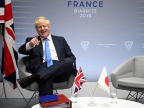 Britain's Prime Minister Boris Johnson sits on a chair after bilateral talks during the G7 summit in Biarritz, France August 26, 2019.